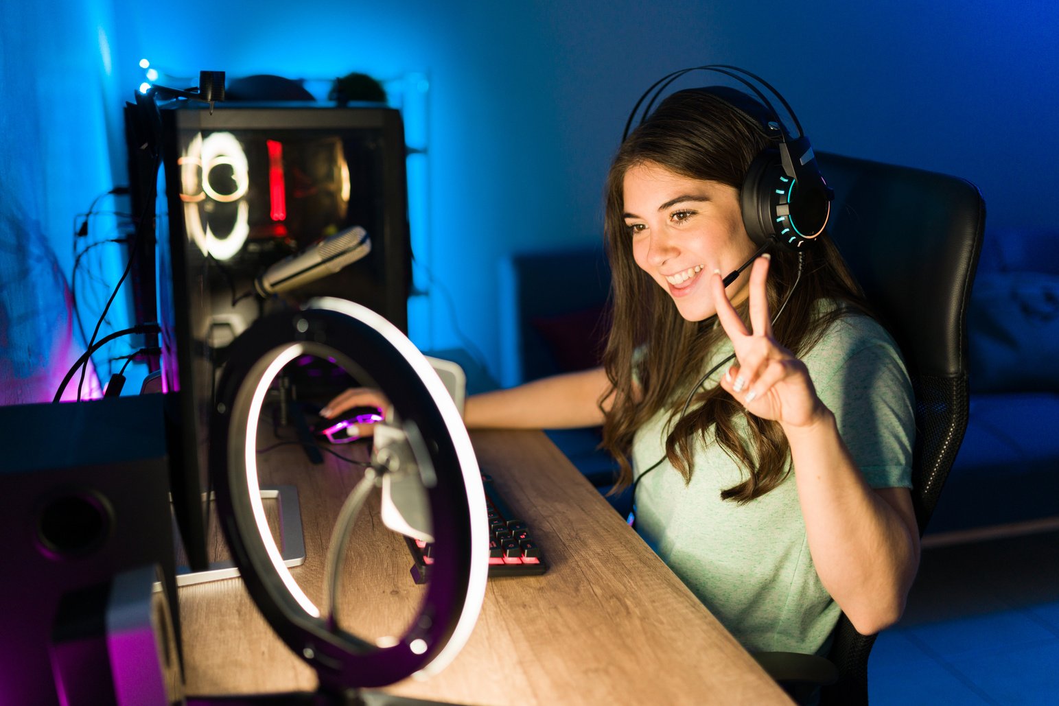 Caucasian woman live streaming while gaming on the computer